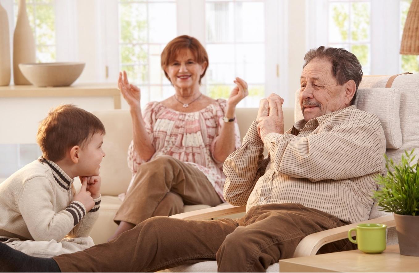 Young boy with mother and grandfather, using sign language